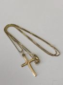 A 14ct gold crucifix and chain, 3.8g. CONDITION REPORT: The chain length 51 cm.