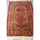 An Afghan rug on red ground 97 cm x 137 cm CONDITION REPORT: This is in good