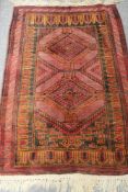 An Afghan rug on red ground 97 cm x 137 cm CONDITION REPORT: This is in good