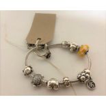 A Pandora silver bracelet with charms and a dress ring (2)