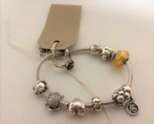 A Pandora silver bracelet with charms and a dress ring (2)