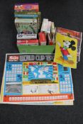 A box of vintage board games, plastic air fix soldiers, mechanical air transport helicopter,