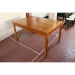 A contemporary pine pull out dining table