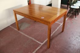 A contemporary pine pull out dining table