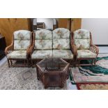 A bamboo and wicker conservatory suite together with a hexagonal two tier coffee table