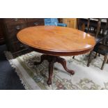 A Victorian oval tilt top breakfast table on four way pedestal