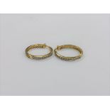 A pair of 10ct gold diamond hoop earrings
