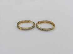 A pair of 10ct gold diamond hoop earrings