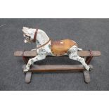 An early twentieth century hand painted rocking horse, missing tail.