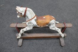An early twentieth century hand painted rocking horse, missing tail.
