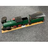 A hand built wooden model of a steam train with carriage