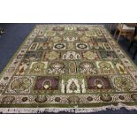 A machine made Persian design fringed carpet of compartmentalised design on green ground