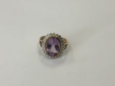 A 9ct gold amethyst and diamond cluster ring, size Q, 5.