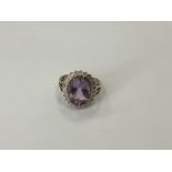 A 9ct gold amethyst and diamond cluster ring, size Q, 5.