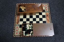 A chess board together with two boxes of chess pieces CONDITION REPORT: Both sets