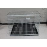A folding metal dog cage width 97 cm