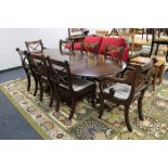 A mahogany Regency style twin pedestal dining table with leaf,