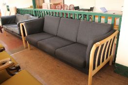 A blond oak framed three seater settee in charcoal fabric CONDITION REPORT: 208cm