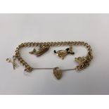 A 9ct gold padlock charm bracelet, 21.7g.