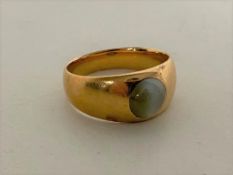 A gold ring with green cabochon stone, marks rubbed, size Q CONDITION REPORT: 6.9g.