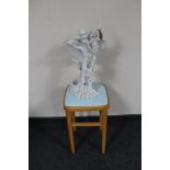 A beech wood stool together with a figure of flower fairy