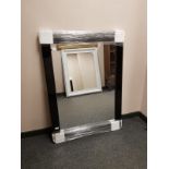 A contemporary black glass framed mirror, 85.