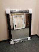 A contemporary black glass framed mirror, 85.