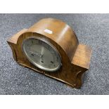 A 1930's walnut cased continental mantel clock with pendulum and key