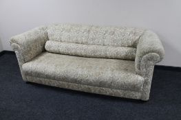 An early twentieth century Chesterfield style settee upholstered in floral fabric