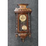 A Victorian stained beech wood wall clock with pendulum