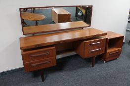 A kneehole dressing table fitted with four drawers together with a G-Plan bedside stand fitted with