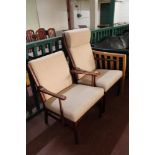A mid century teak armchair and fireside chair in beige fabric