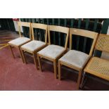 A set of four contemporary oak dining chairs with grey fabric seats