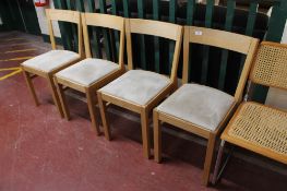 A set of four contemporary oak dining chairs with grey fabric seats