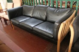 A contemporary wooden framed three seater settee in black leather CONDITION REPORT: