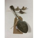 A silver jam spoon together with three white metal miniature swans