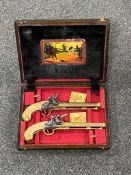 A pair of replica duelling pistols in fitted case