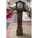 An oak cased granddaughter clock with pendulum and key