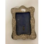 A silver embossed photograph frame
