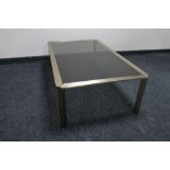 A metal and glass topped coffee table