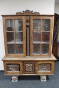 A 20th century continental carved oak display cabinet CONDITION REPORT: Height 184