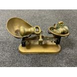 A set of antique brass kitchen scales with weights