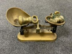 A set of antique brass kitchen scales with weights