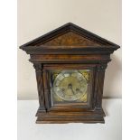 An antique pine cased bracket clock with brass and silvered dial with pendulum