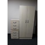 A double door wardrobe and pair of matching three drawer chests