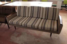 A mid century Danish teak armed three seater settee in a striped fabric CONDITION