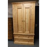 A pine double door wardrobe, width 108 cm height 205 cm, depth 60.5 cm, internal rail length 95 cm.