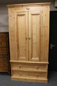 A pine double door wardrobe, width 108 cm height 205 cm, depth 60.5 cm, internal rail length 95 cm.