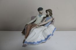 A Nao figure of a couple sat on a couch