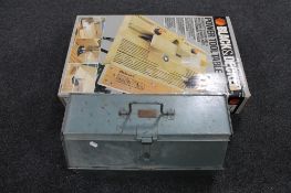 A boxed Black and Decker power tool table together with a metal tool box